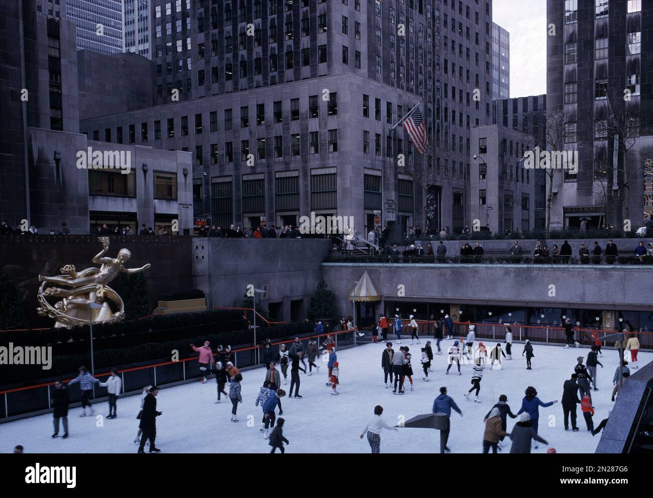 Ice skaters glide around the Rockefeller Center ice skating rink in New