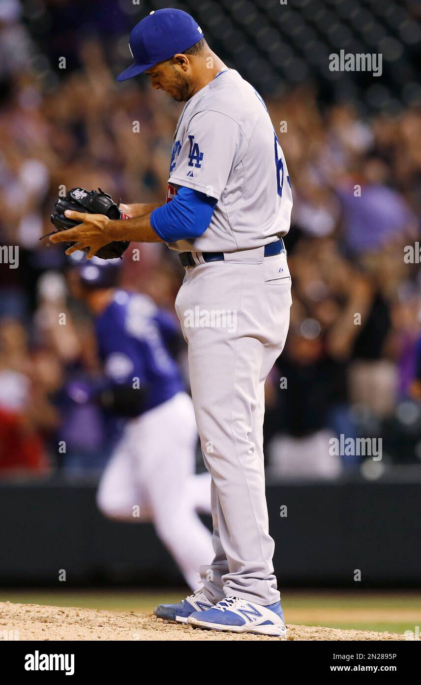 Los Angeles Dodgers relief pitcher Yimi Garcia, front, pounds his