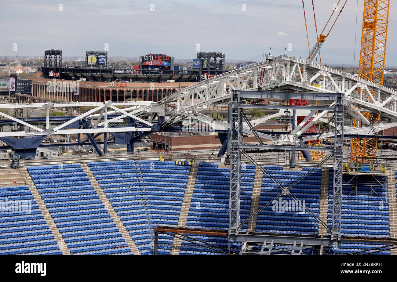 Parts of the new roof over Arthur Ashe Stadium are held up by temporary