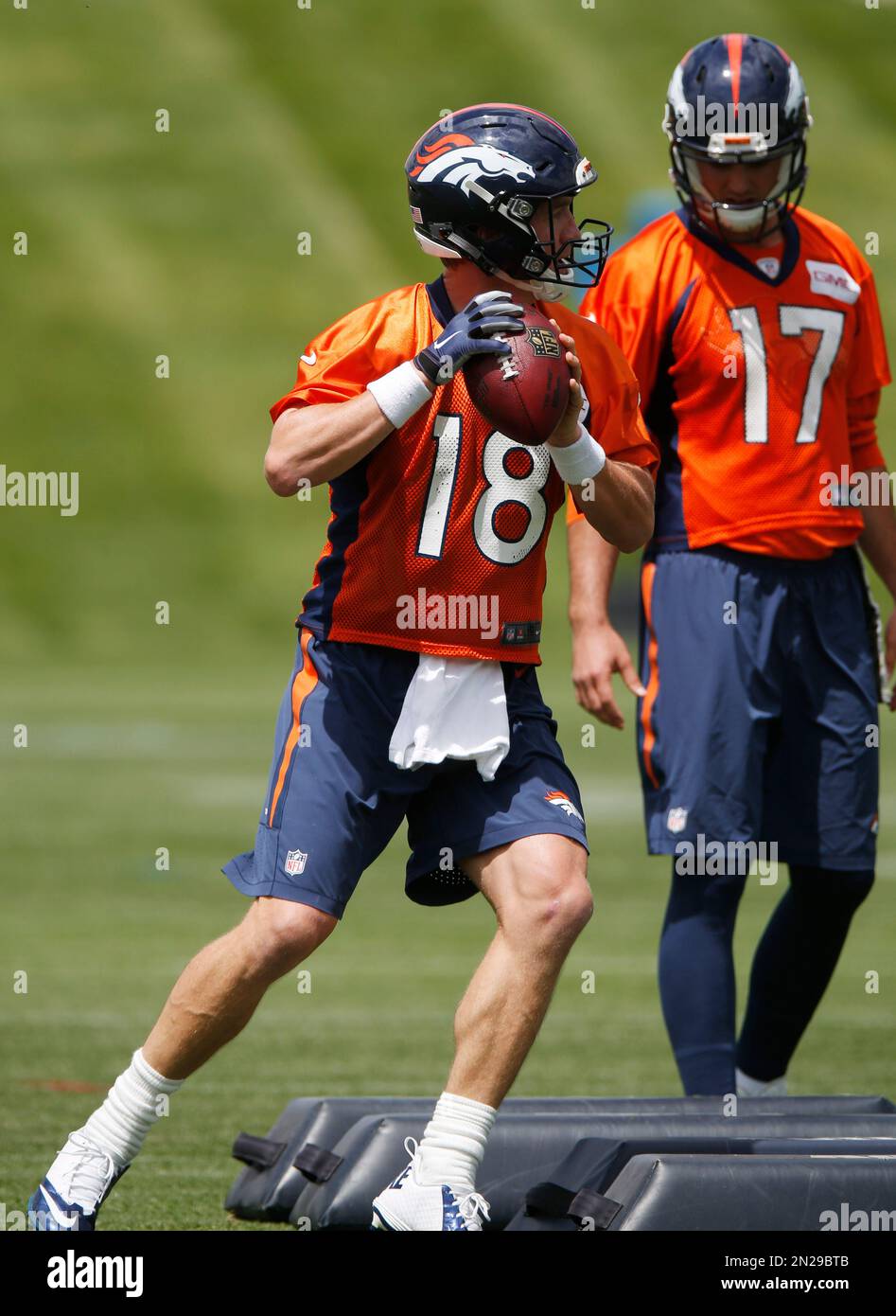 Denver Broncos quarterback Peyton Manning, front, takes part in a drill ...
