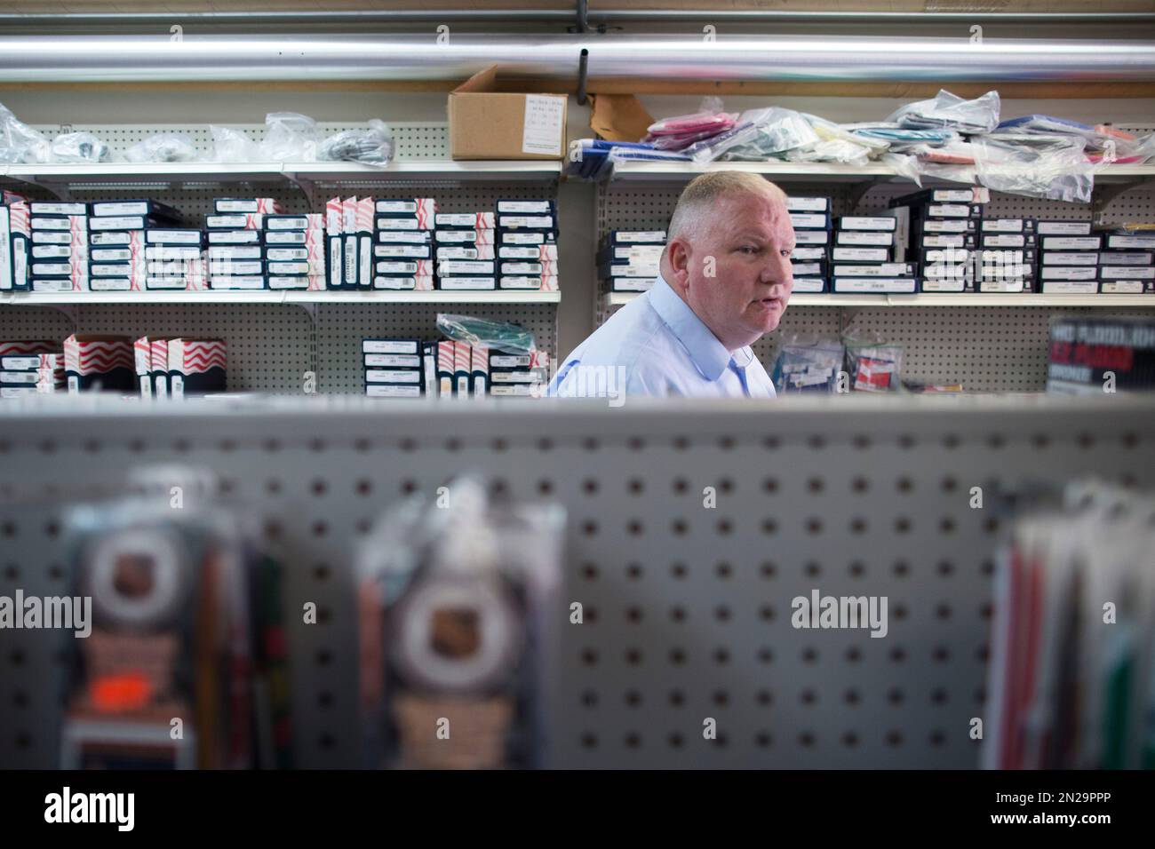 Army veteran Jim Farrell, owner of Lawson Flag Supply Co., searches