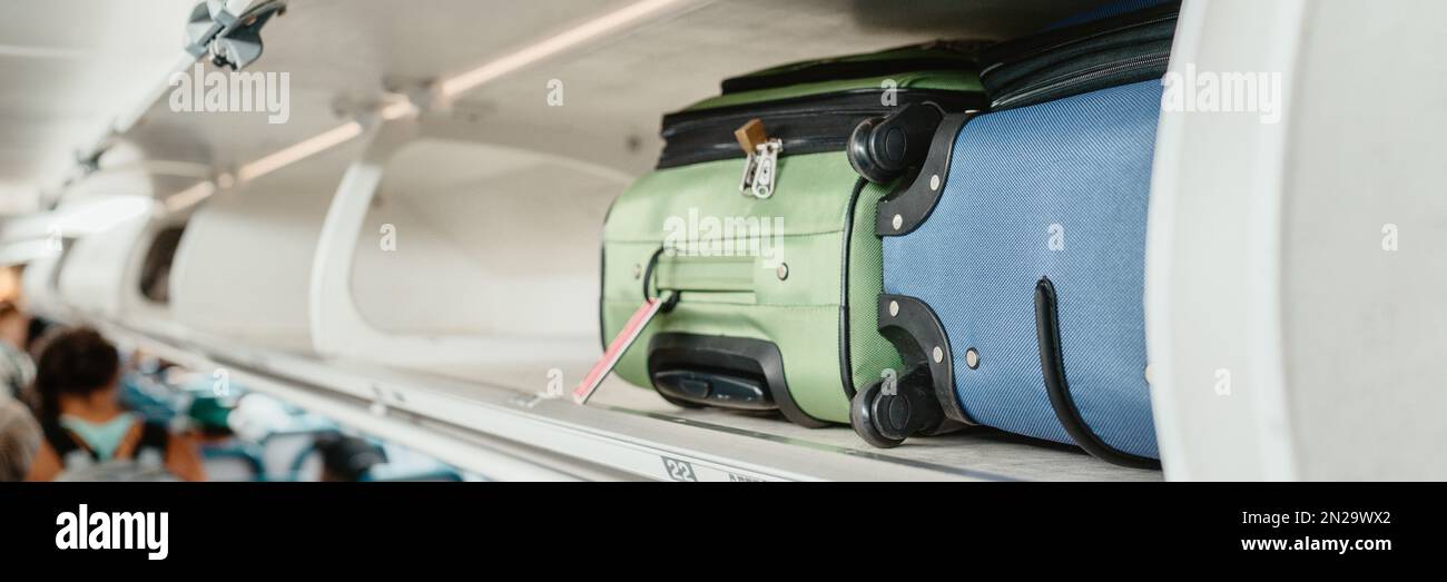 Carryon luggages in overhead compartment of plane for international