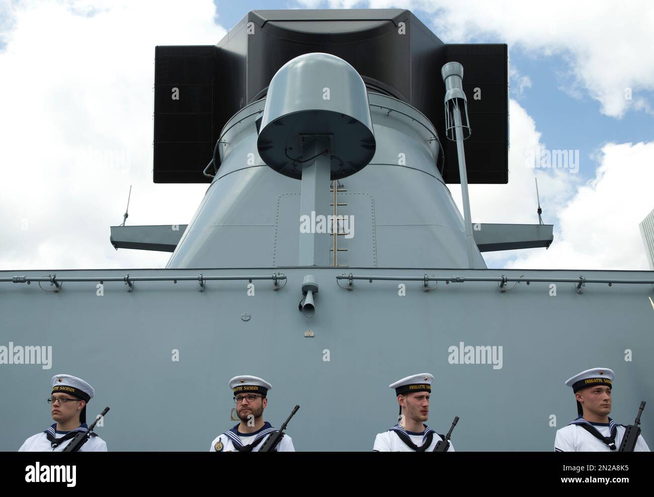 Sailors from the German frigate F219 Sachsen form a honour guard as ...
