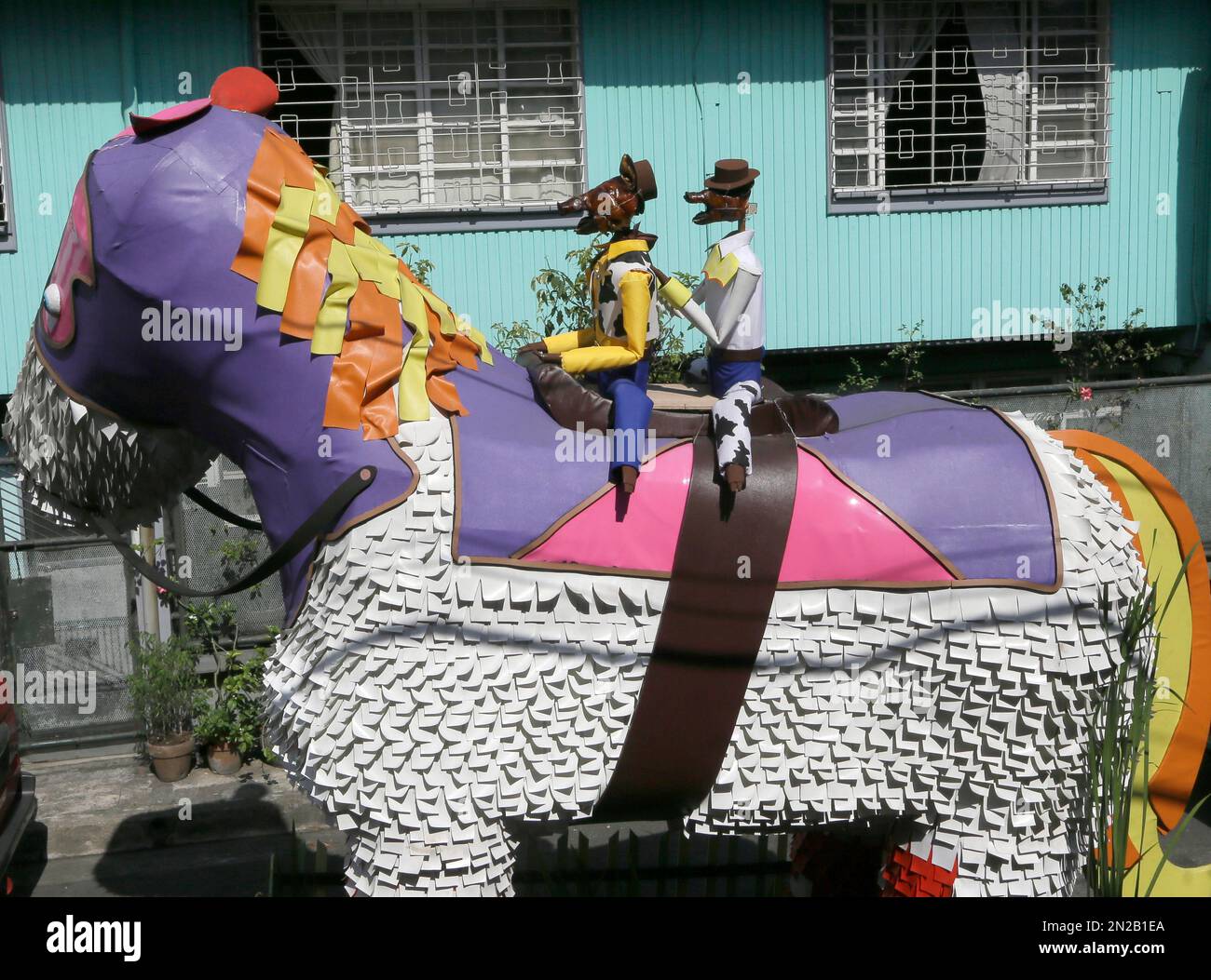 A float with roast pigs dressed as characters of a popular computer  animated film is paraded through the streets of La Loma district in Quezon  city to celebrate the annual 