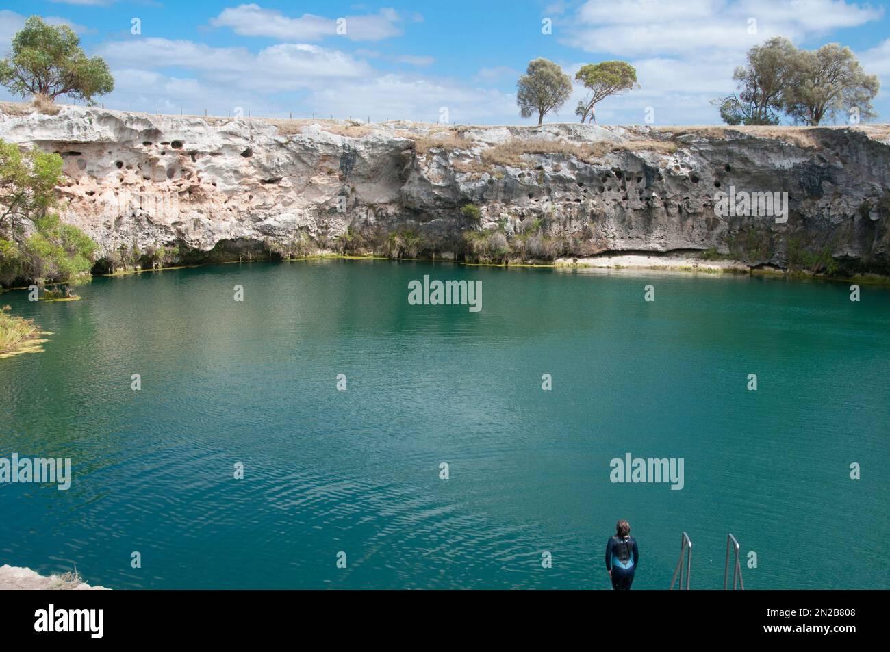 Swimmers enjoying a dip at the Little Blue Lake south of Mount Gambier, southeastern South Australia Stock Photo