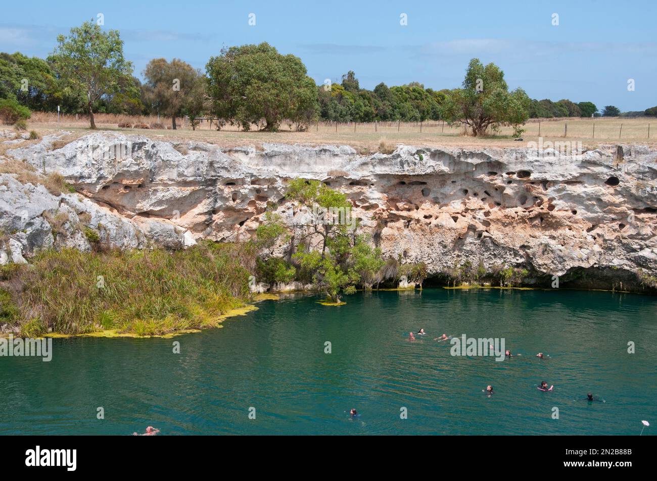 Swimmers enjoying a dip at the Little Blue Lake south of Mount Gambier, southeastern South Australia Stock Photo