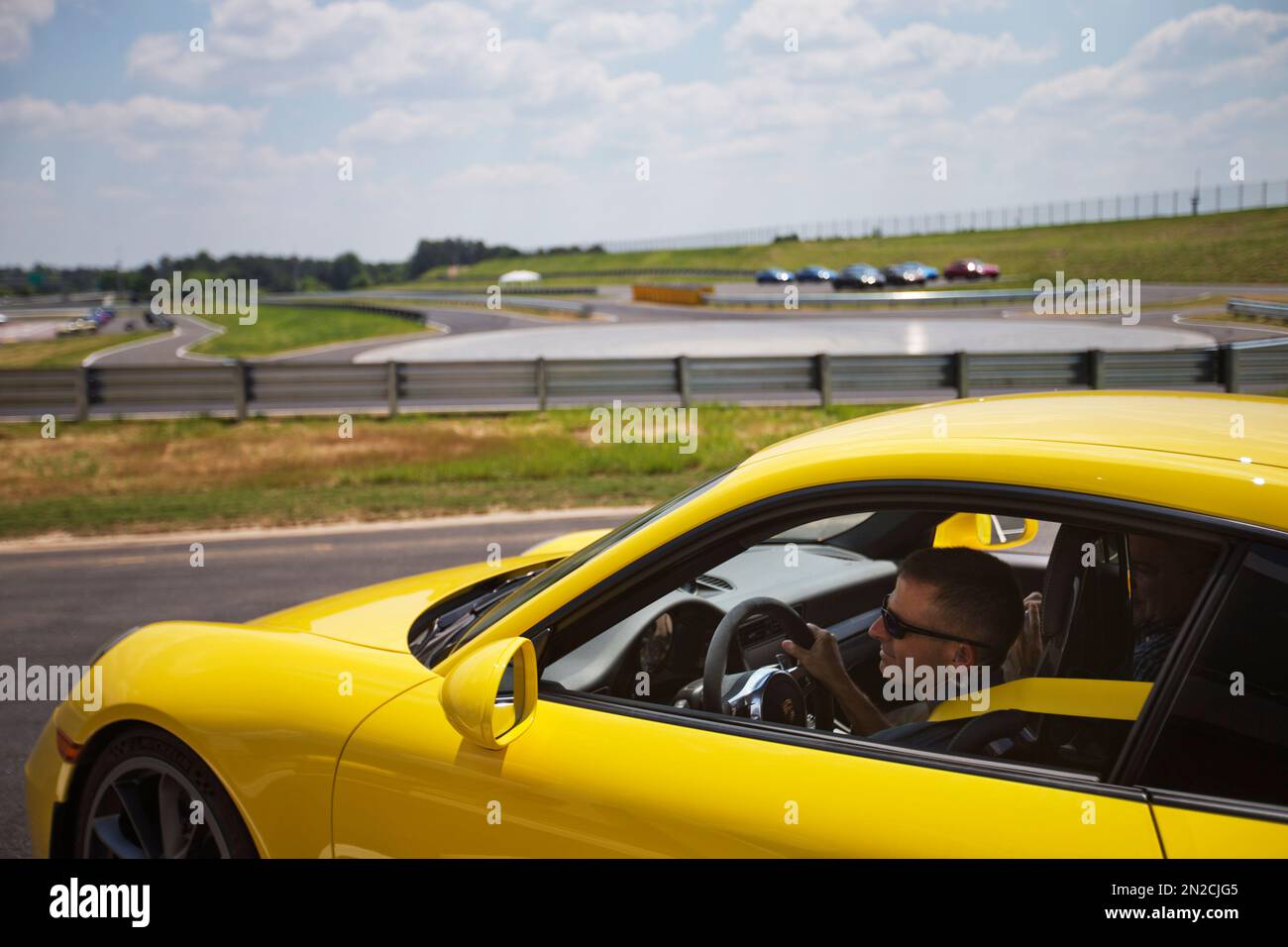 Brian Cunningham Racing Brian Cunningham, chief instructor, drives a Porsche sports car through ...
