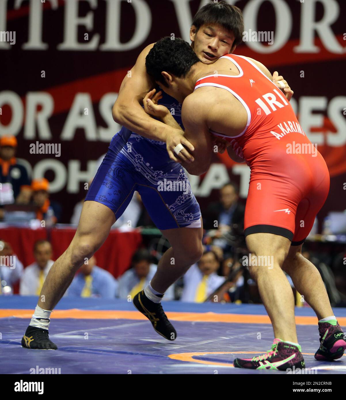 Japanese wrestler Atsushi Matsunoto, left, wrestles Iranian wrestler 