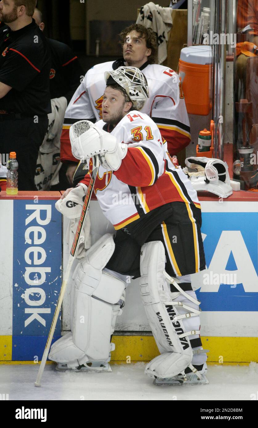 Calgary Flames goalies Karri Ramo, front, of Finland, and goalie Jonas Hiller, of Switzerland, watch a replay during the third period of Game 2 in the second round of the NHL Stanley