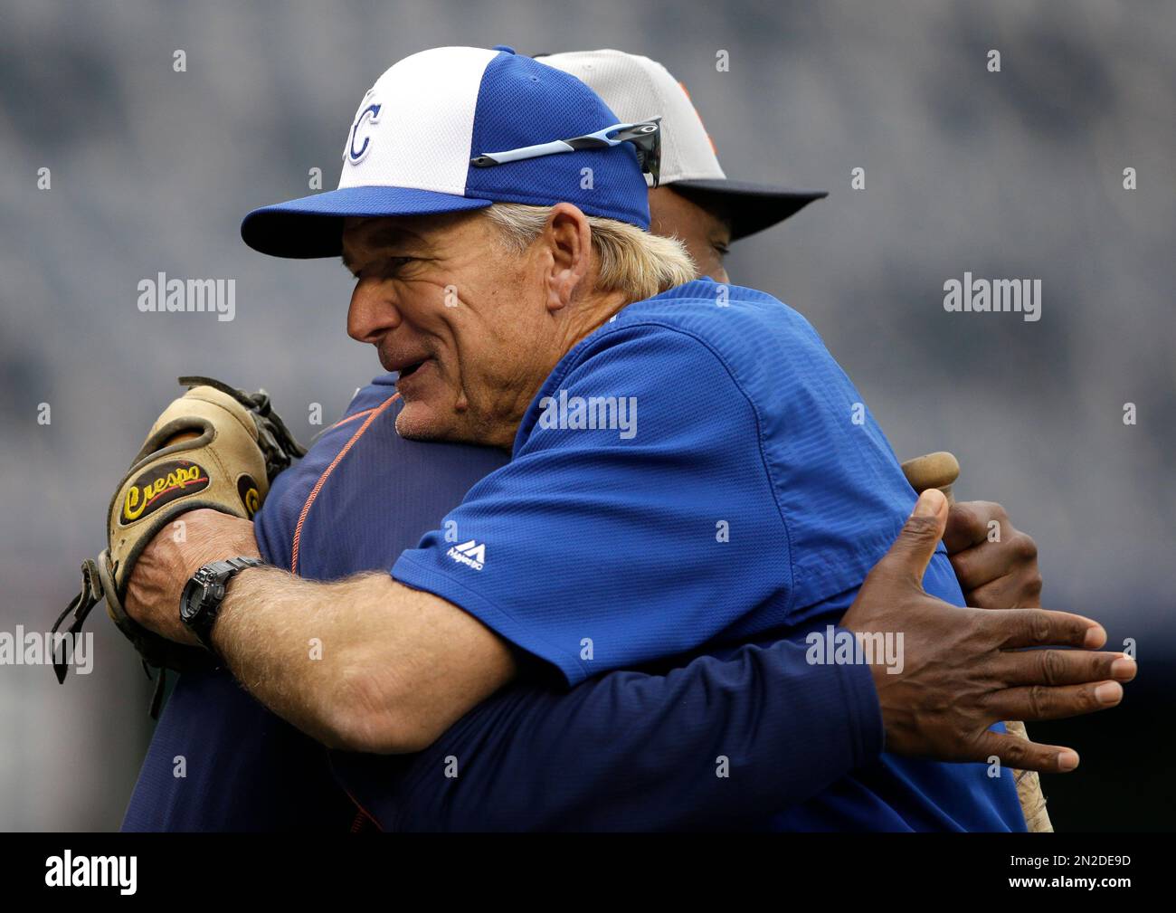 Kansas City Royals first base coach Rusty Kuntz hugs Detroit Tigers