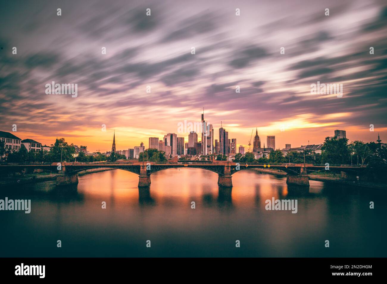 Pink sunset over the river Main, illuminated skyline of the city of Frankfurt am Main, Hesse