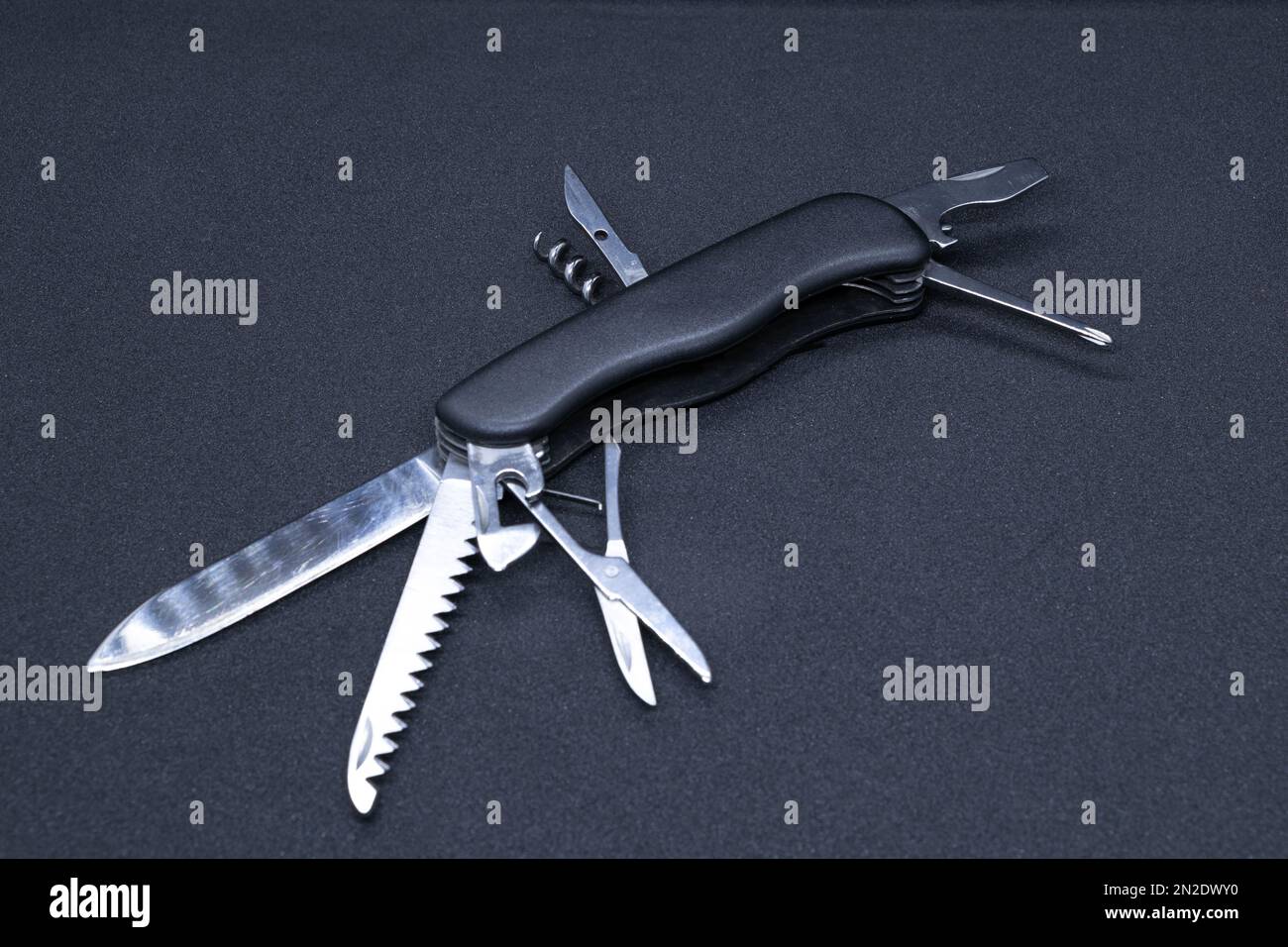 A Multitool in black background Stock Photo