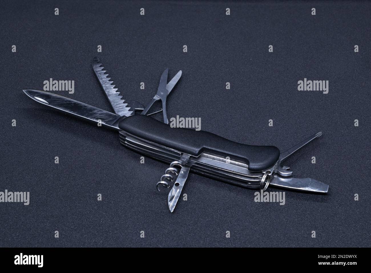 A Multitool in black background Stock Photo