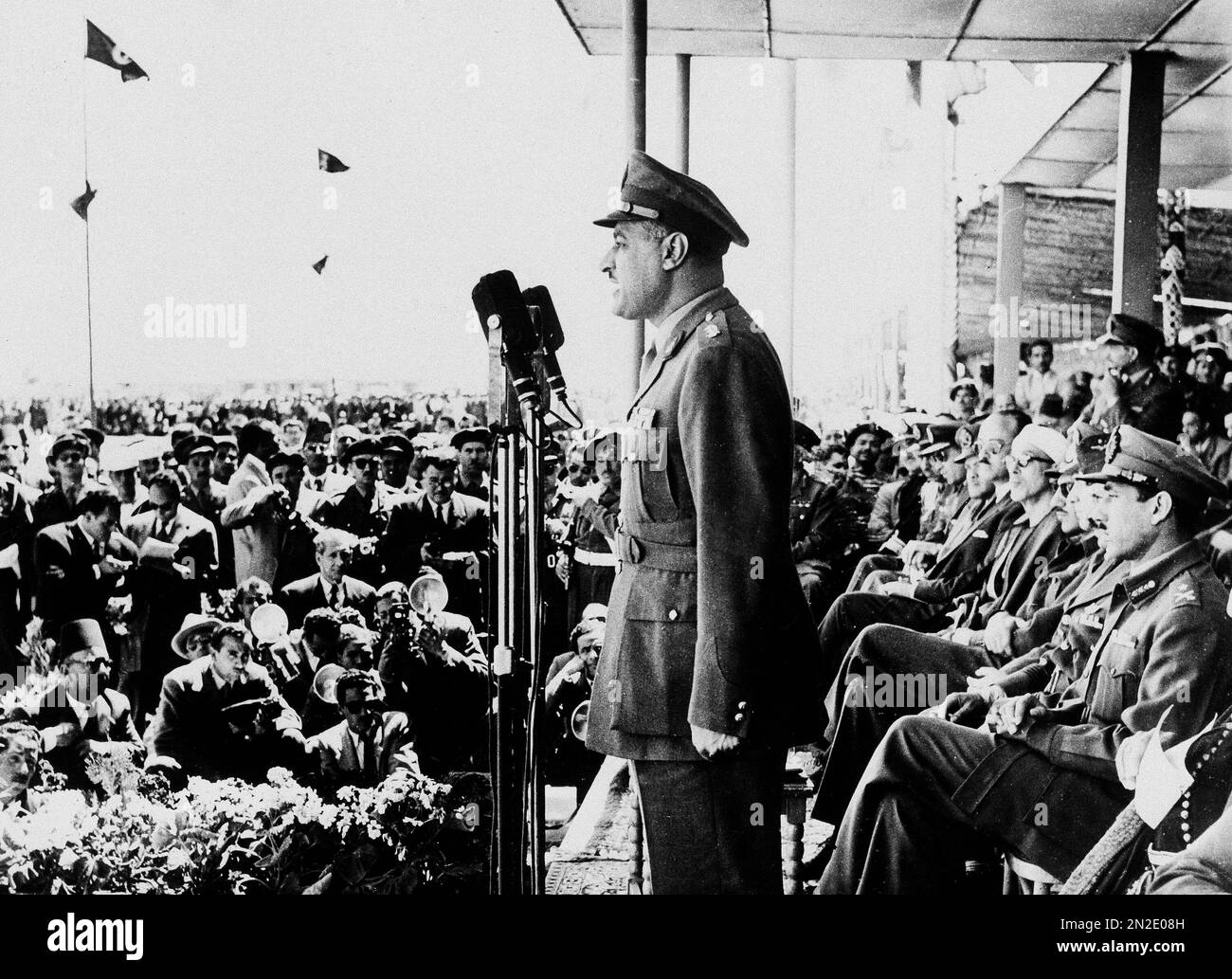 President Gamal Abdel Nasser addresses Egyptian troops on parade during
