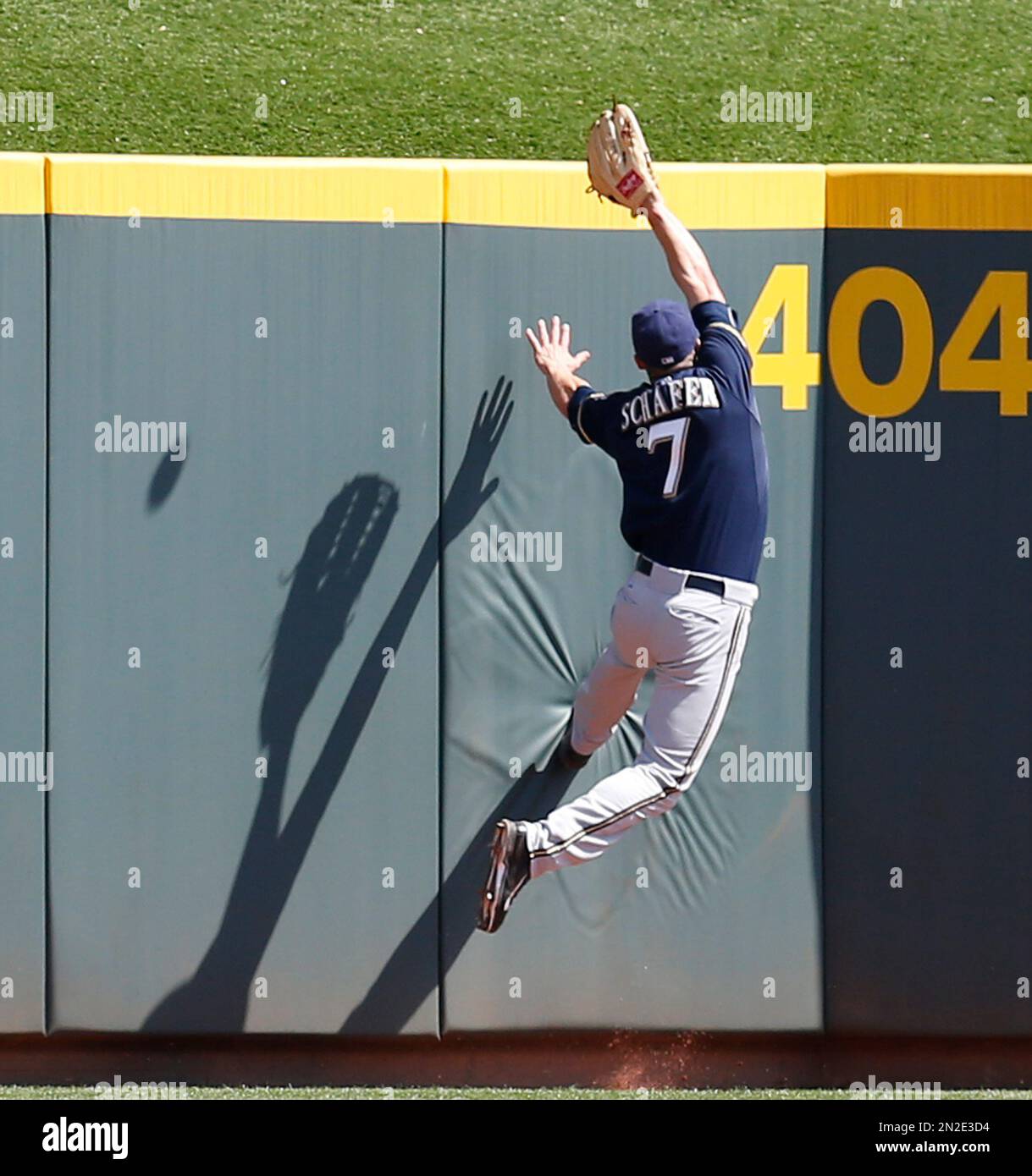 Milwaukee Brewers' outfielder Logan Schafer (7) hits the wall in an