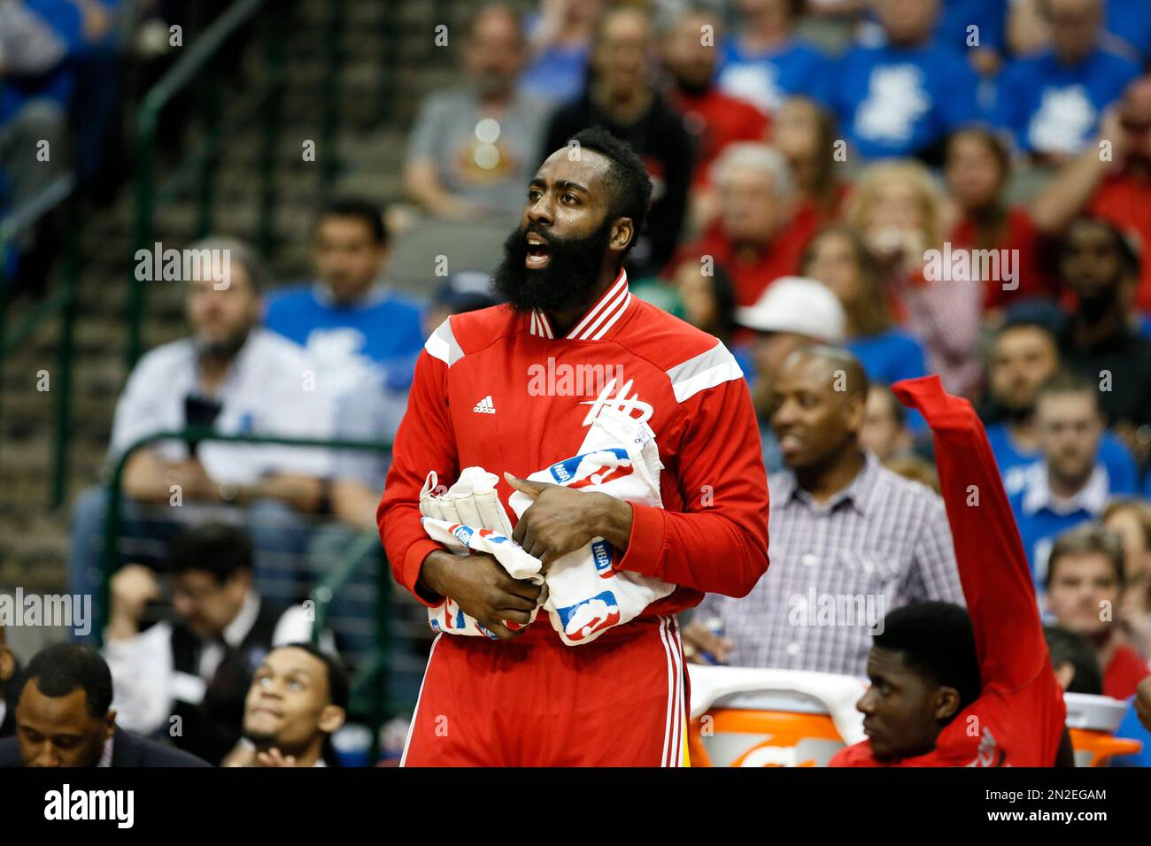 Houston Rockets' James Harden cheers on his team from the bench during