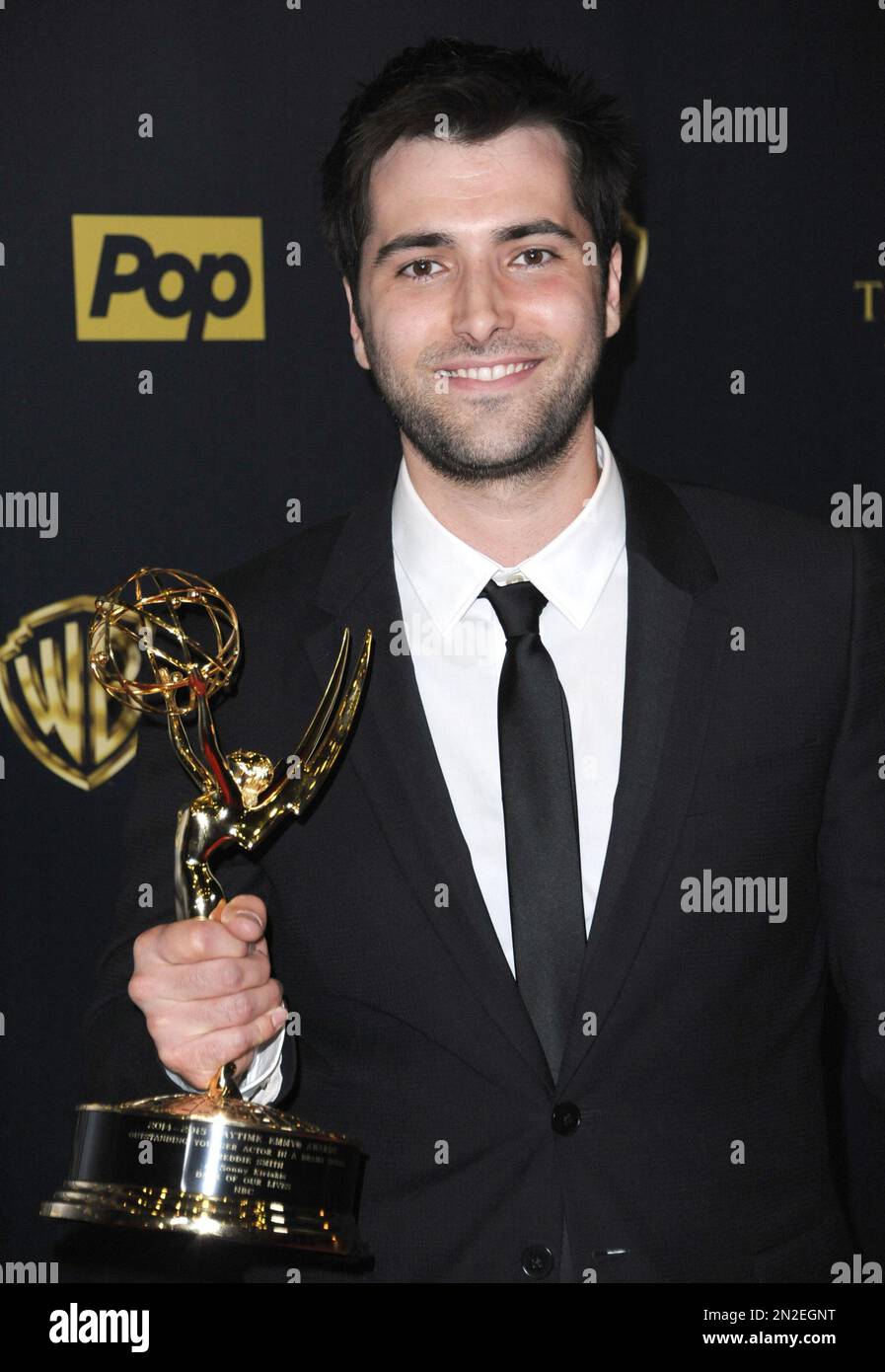 Freddie Smith poses in the pressroom with the award for outstanding