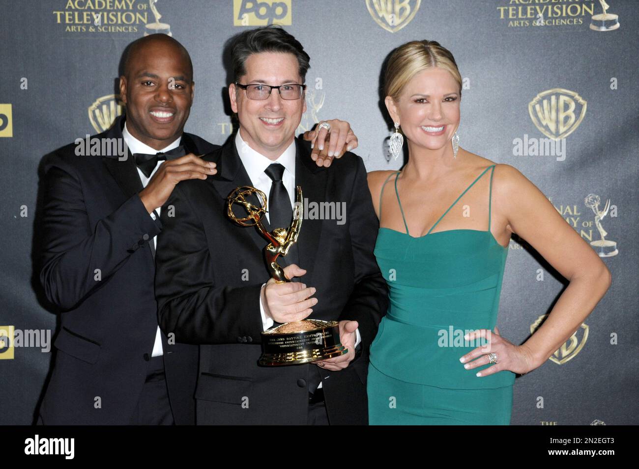 Kevin Frazier, from left, Brad Bessey, and Nancy O’Dell pose in the