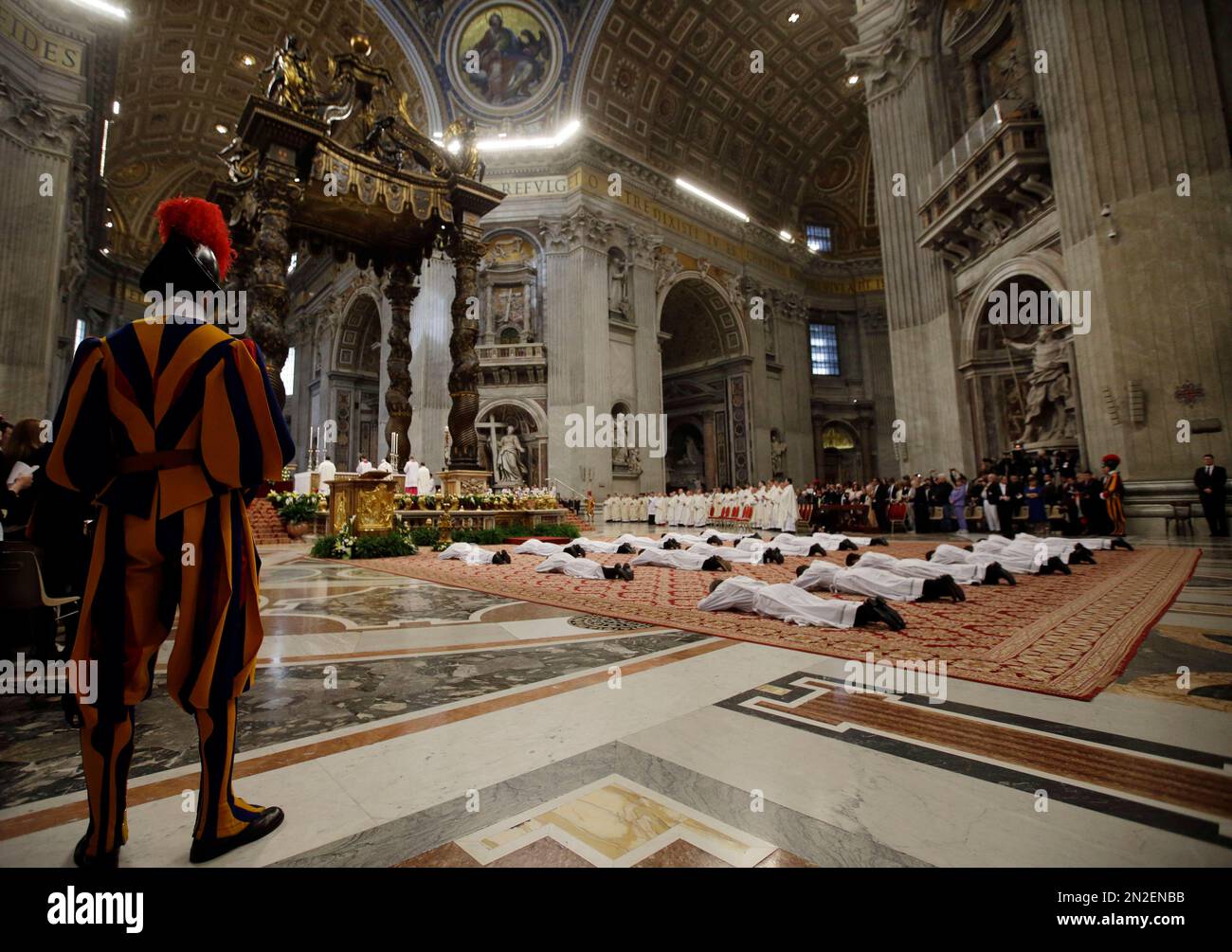 new priests lay on the ground during a ceremony in which Pope Francis ordained them, in