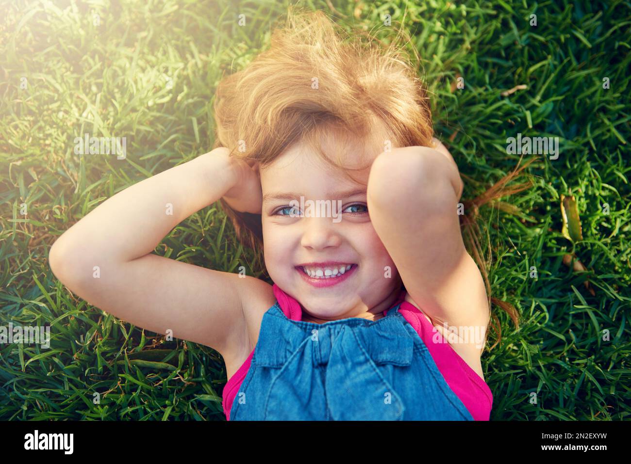 Little girls are heavens flowers. a little girl having fun on the lawn. Stock Photo