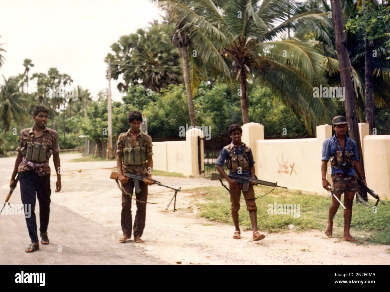 heavily-armed-tamil-tiger-rebels-walk-down-a-street-in-achchuveli-village-north-east-of-jaffna-city-sri-lanka-on-nov-4-1987-ap-photo-2N2FCM9.jpg