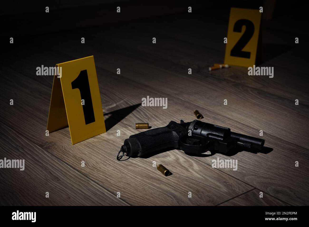 Gun and shell casings on wooden floor at crime scene Stock Photo - Alamy