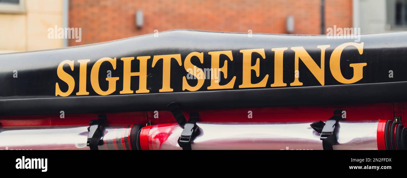 Red City tour car in the old city with text sign of Sightseeing city