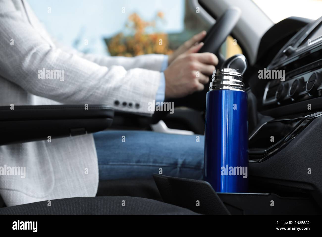 Blue thermos in holder inside of car Stock Photo Alamy