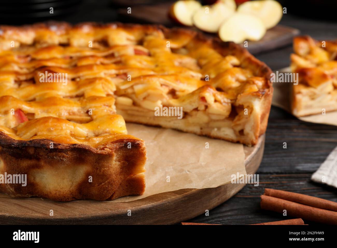 Traditional apple pie on black wooden table, closeup Stock Photo
