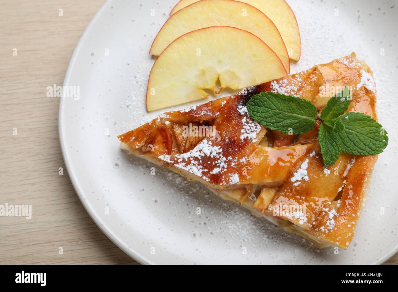 Slice of traditional apple pie on wooden table, top view Stock Photo