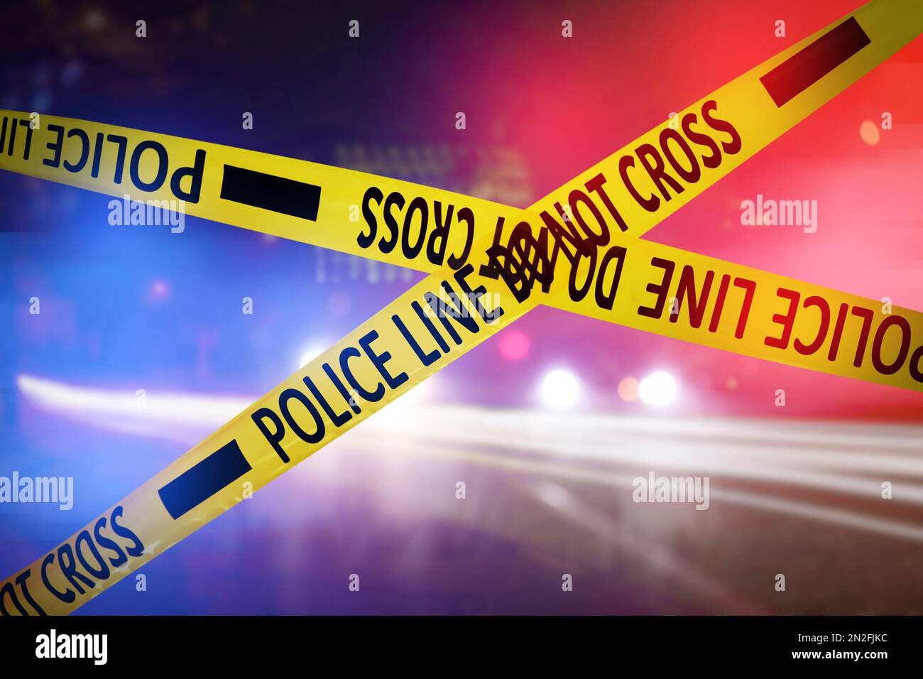 Yellow law enforcement tape isolating crime scene. Blurred view of city