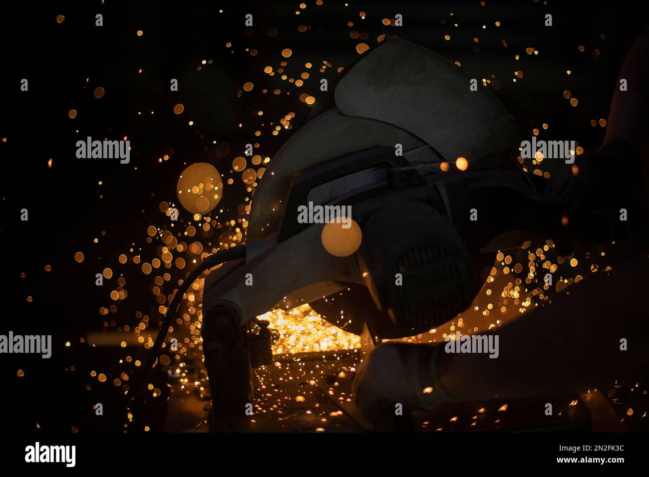Sparks from welding. Metal cutting. Production details. Industrial background. Stock Photo