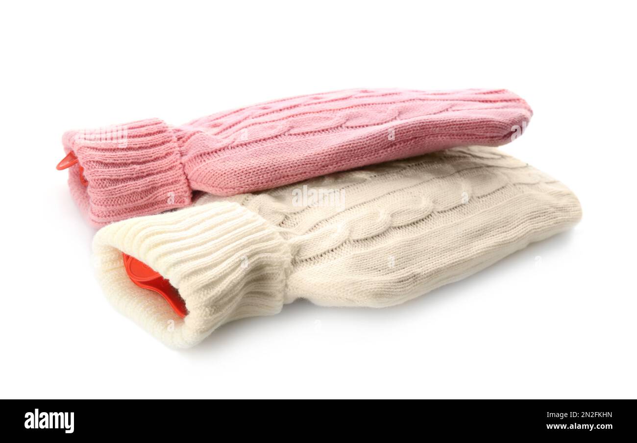 Hot water bottles with knitted covers isolated on white Stock Photo Alamy