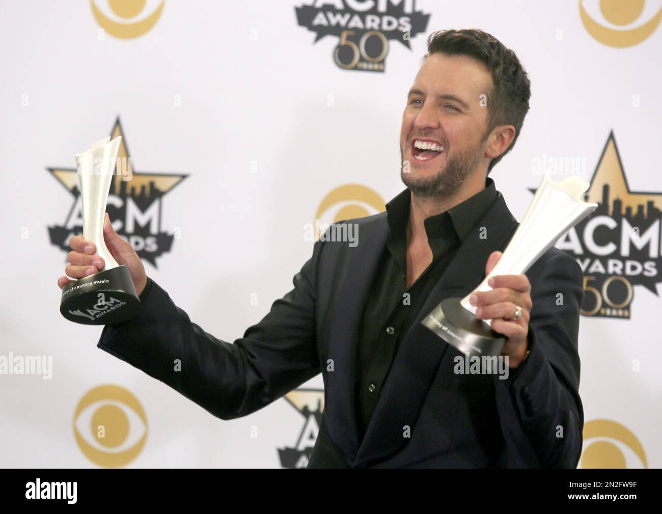 Luke Bryan poses in the press room with the awards for entertainer of(02)