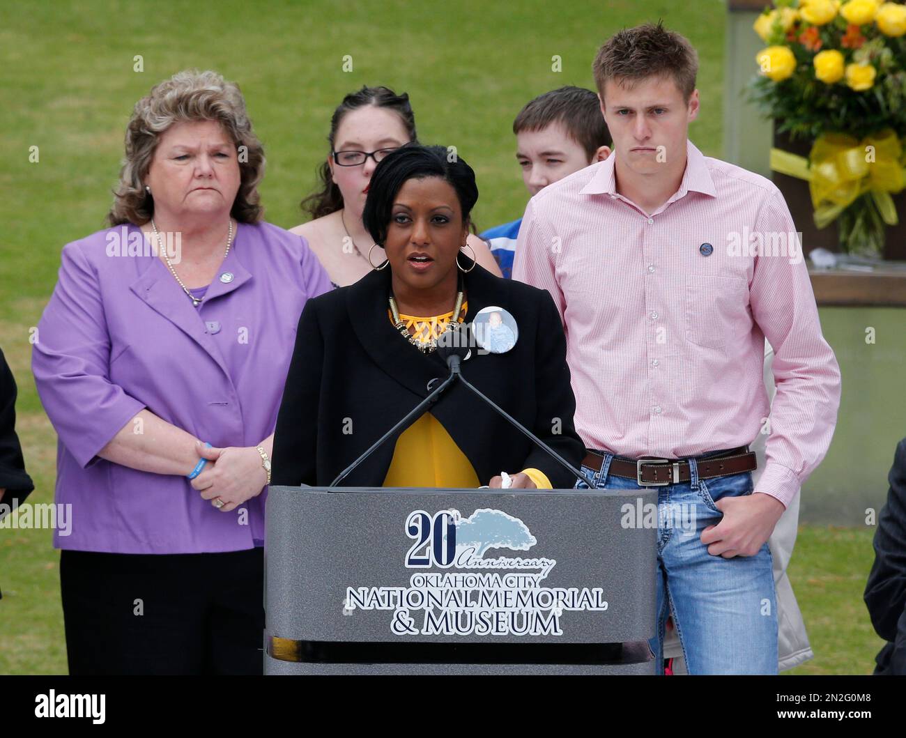 Helena Garrett, center, mother of bombing victim Tevin Garrett, speaks