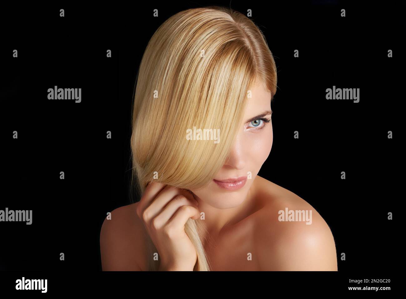Her natural beauty shines against a black backdrop. Head and shoulders ...