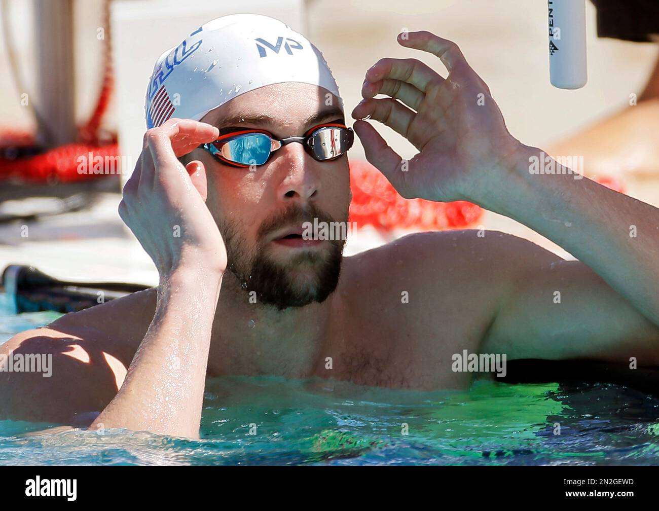 Michael Phelps takes off his goggles after competing in the men s 100 meter butterfly preliminary Thursday April 16 2015 at the Arena Pro Swim Series in Mesa Ariz. The race was the