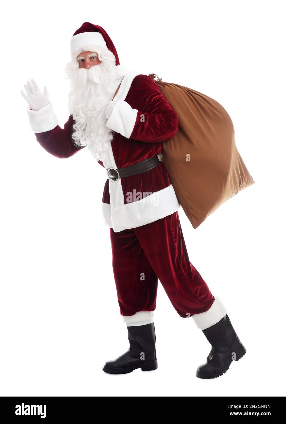 Santa Claus with sack walking on white background Stock Photo