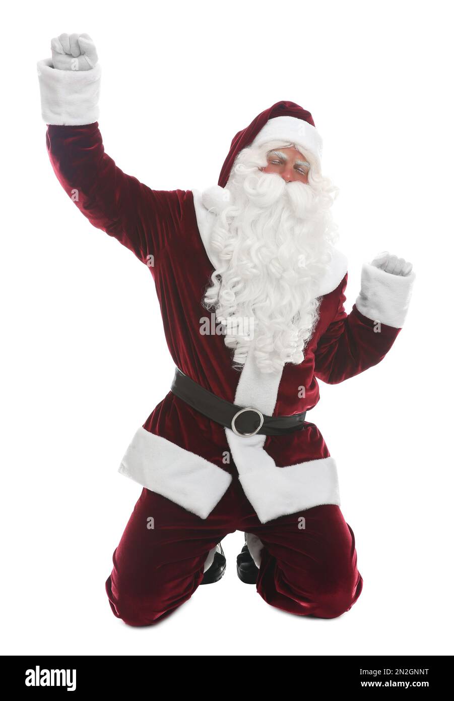 Joyful Santa Claus standing on knees against white background Stock Photo