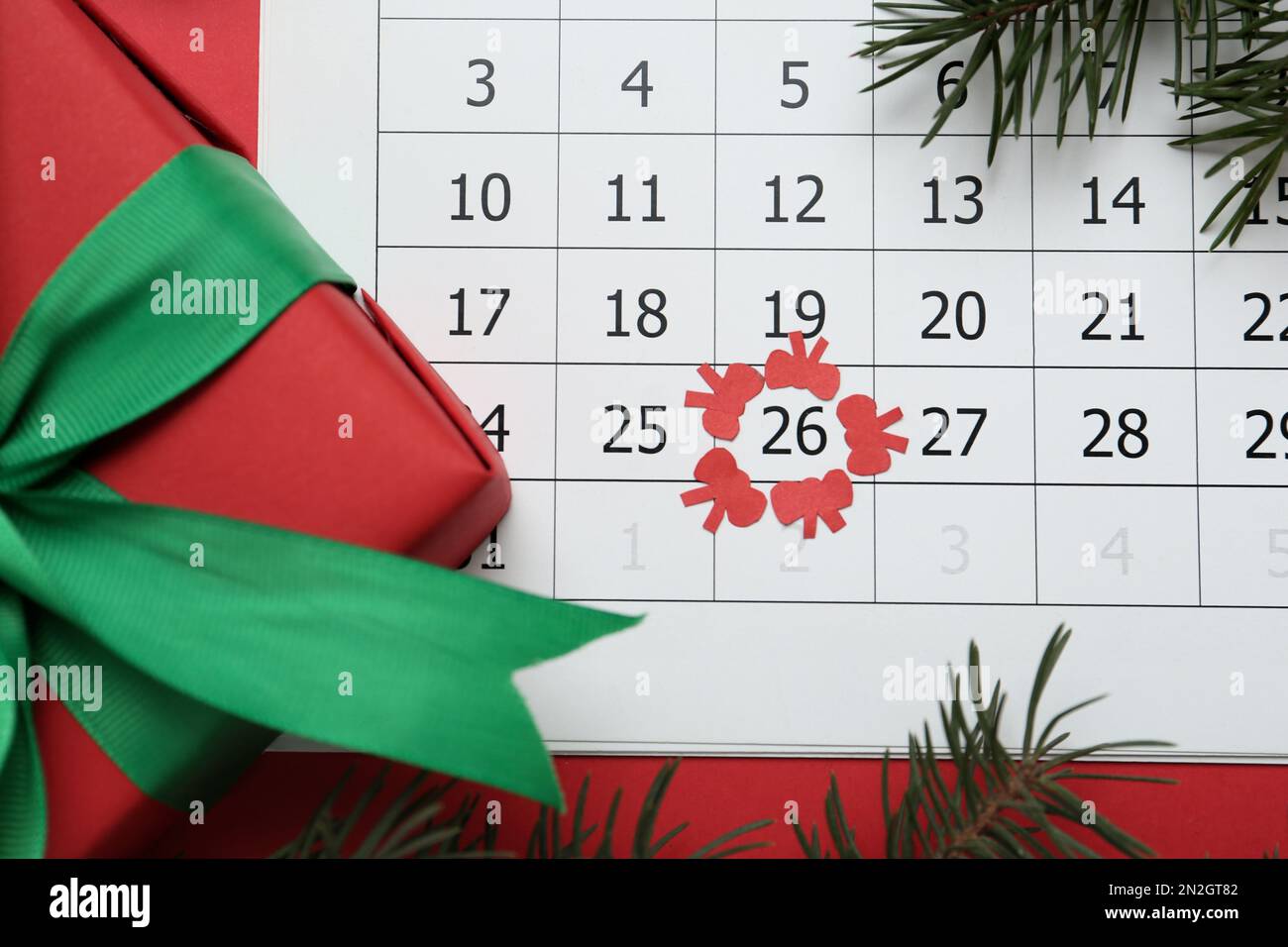 Gift on calendar with marked Boxing Day date, flat lay Stock Photo