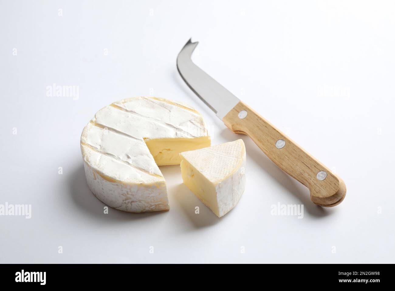 Cut Camembert cheese and knife on white background Stock Photo Alamy
