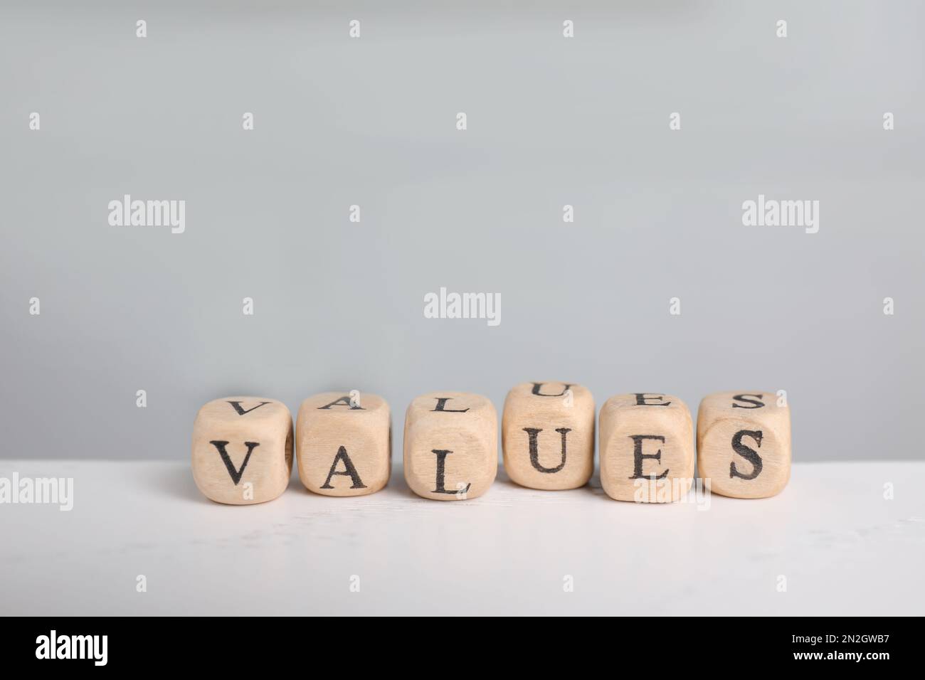 Beads with word VALUES on white table Stock Photo