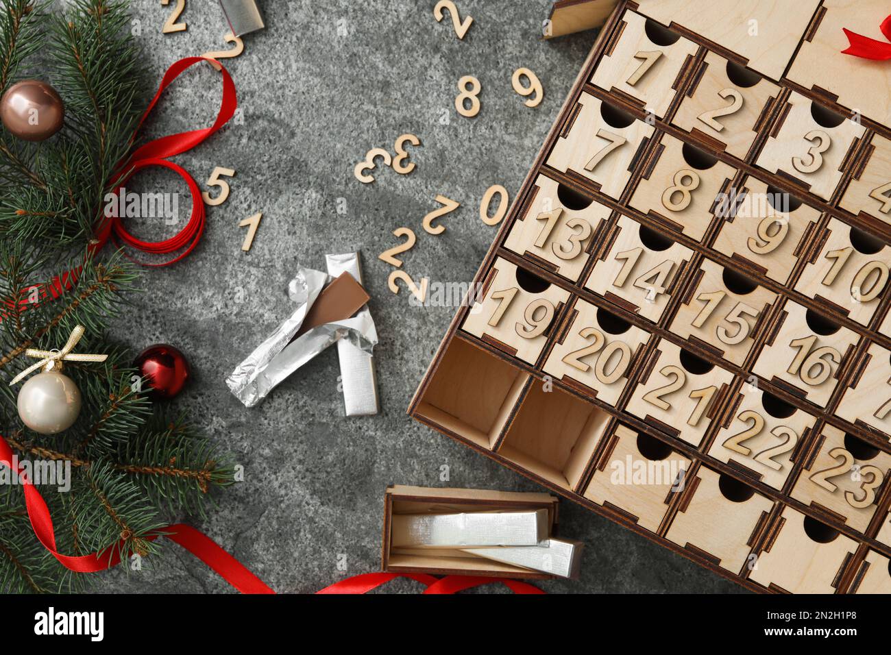 Flat lay composition with wooden advent calendar and Christmas decor on