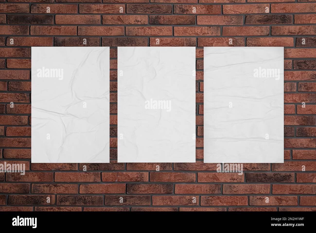 Blank creased posters on brick wall. Mockup for design Stock Photo Alamy