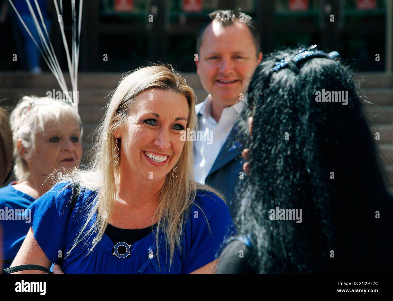 Sky Hughes, middle, and her husband, Chris, top, exit Maricopa County  Courthouse after a judge sentenced Jodi Arias to life in prison without the  possibility of release for the murder of Travis, image size:1300x996