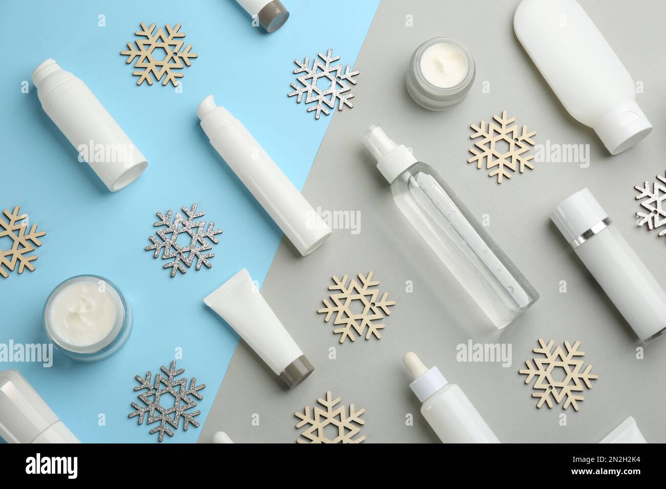 Flat lay composition with cosmetic products on light blue and grey ...