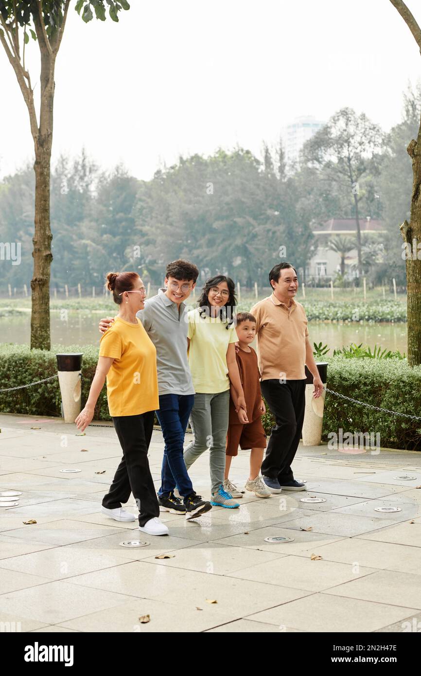 Big happy family walking together in city park Stock Photo - Alamy