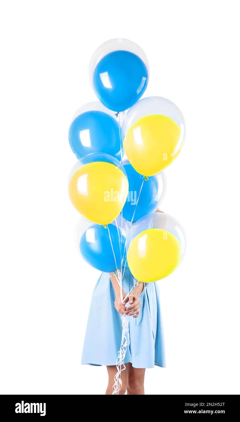 Woman hiding behind balloons in colors of Ukrainian flag on white background Stock Photo