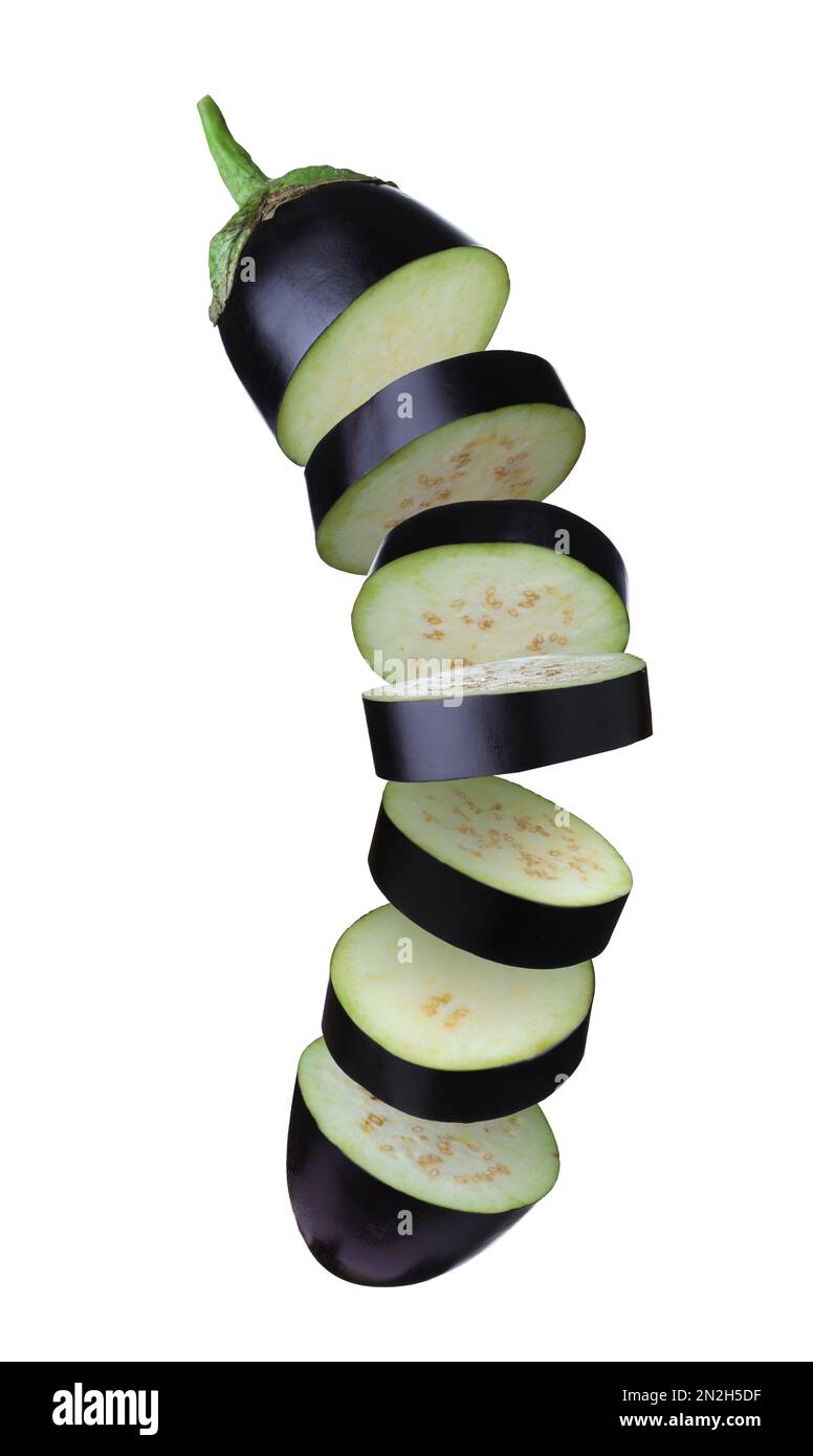 Cut fresh eggplant pieces falling on white background Stock Photo Alamy