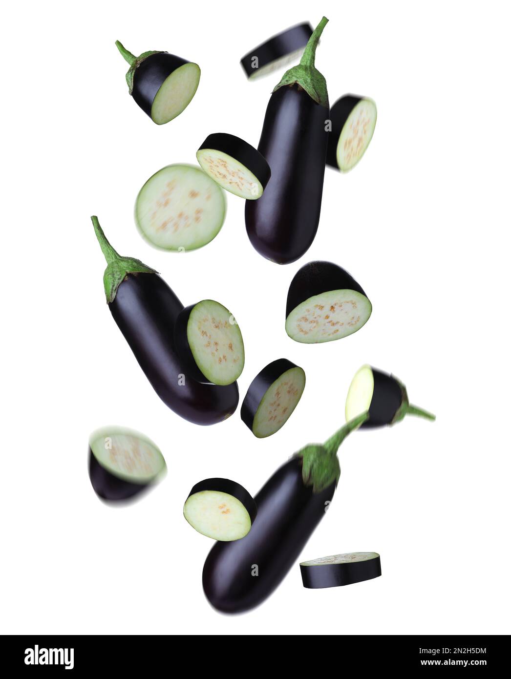 Cut and whole eggplants falling on white background Stock Photo Alamy